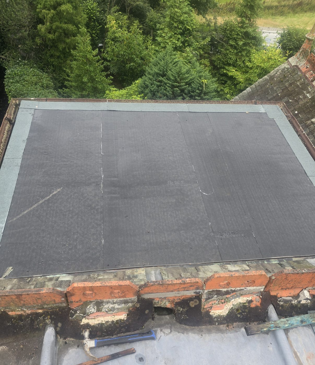 New flat roof with a brick parapet by Thistle Roofing and Building